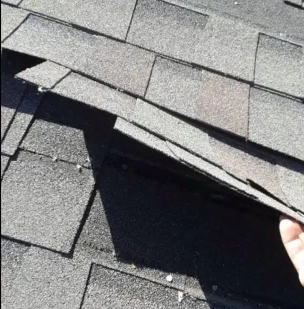 A storm damaged shingle roof in Dallas, Texas